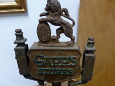 A VINTAGE GAPPS STORES SHOP SCALE WITH RAMPANT LION AND JUSTICE-STRENGTH SHIELD SURMOUNT.