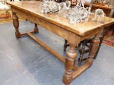 A LATE VICTORIAN OAK REFECTORY TABLE ON BULBOUS CUP AND COVER TURNED LEGS UNITED BY H-STRETCHER. 183