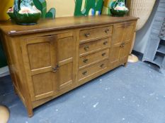 ALAN GRAINGER. ACORNMAN. A HAND MADE OAK SIDEBOARD/DRESER BASE WITH ADZE CUT TOP OVER FOUR CENTRAL