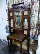 A LATE VICTORIAN OAK HALL STAND WITH INSET CERAMIC TILES AND BRASS STICK SUPPORTS. W.107 x H.