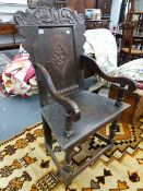 AN 18th.C.OAK WAINSCOTT CHAIR WITH CARVED BACK PANEL AND SHAPED ARMS.H. (AT BACK) 102cms, SEAT H.