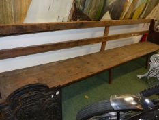 AN ANTIQUE RUSTIC PINE BENCH, REPUTEDLY FROM THE QUAKER MEETING HOUSE AT SHIPSTON ON STOUR.