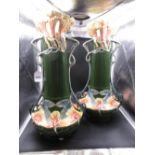 AN IMPRESSIVE PAIR OF CONTINENTAL ART NOUVEAU POTTERY TWIN HANDLED VASES WITH FLOWER AND LEAF