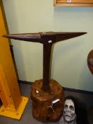 AN ANTIQUE IRON BOUND BLACKSMITH'S TALL ANVIL, STAKE LATER FITTED TO HEAVY STUMP WOOD BASE.