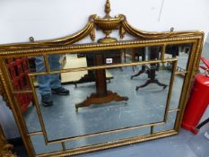 A REGENCY STYLE GILT FRAMED MARGINAL WALL MIRROR WITH URN AND SWAG CREST. 106 x 96cms.