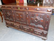 AN 18th.C.OAK MULE CHEST WITH PLANK TOP OVER GEOMETRIC PANEL FRONT AND TWO CONFORMING BASE