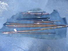 TWO VINTAGE LACROSSE STICKS, VARIOUS FISHING RODS, AN EASTERN SWORD, GUN SLIPS, RIDING CROP,ETC. (