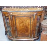 A VICTORIAN WALNUT AND INLAID CREDENZA WITH CENTRAL PANEL DOOR FLANKED BY BOW GLAZED SIDE