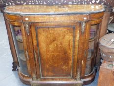 A VICTORIAN WALNUT AND INLAID CREDENZA WITH CENTRAL PANEL DOOR FLANKED BY BOW GLAZED SIDE