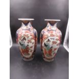 A PAIR OF JAPANESE IMARI VASES EACH PAINTED WITH TWO RESERVES OF A MOTHER AND CHILD IN A FLOWER