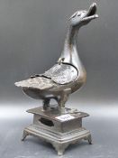 A CHINESE BRONZE DUCK CENSER STANDING ON A PLINTH WITH FOUR BRACKET LEGS, IT'S OPEN BEAK TURNED TO