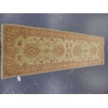 AN ORIENTAL RUNNER OF ZIEGLER DESIGN. 244 x 77cms.