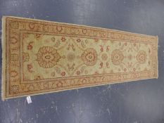 AN ORIENTAL RUNNER OF ZIEGLER DESIGN. 244 x 77cms.