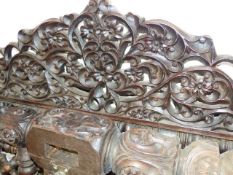 AN ANTIQUE COLONIAL HARDWOOD CARVED BED FRAME. W.119cms.