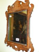 A SMALL ANTIQUE WALNUT FRET FRAME WALL MIRROR. 36 x 52cms.