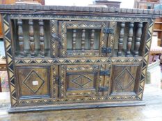 AN 18th.C.AND LATER REMADE OAK CABINET WITH SPINDLE GALLERIED UPPER SECTION OVER INLAID PANEL LOWER.