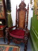 A VERY IMPRESSIVE PAIR OF CARVED HARDWOOD THRONE CHAIRS WITH HIGH BACKS OVER LION MASK ARMS AND