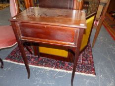 AN EDWARDIAN MAHOGANY WORK TABLE WITH RISING TOP ENCLOSING WRITING SLOPE AND FOLD OUT SEWING