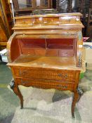 A FRENCH STYLE INLAID ORMOLU MOUNTED LADIES CYLINDER BUREAU WITH FITTED INTERIOR ABOVE TWO DRAWERS.
