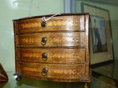 A 19th.C.CONTINENTAL VELLUM MOUNTED MINIATURE CHEST OF FOUR DRAWERS, THE BRASS RING HANDLES