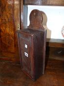 AN 18th.C.OAK CANDLE BOX WITH SLIDING LID. H.48cms.