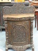 A 19th.C.CARVED BURMESE TEAK SMALL BOW FRONT SIDE CABINET WITH SINGLE FRIEZE FOLIATE PIERCED DOOR