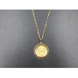 A 22ct 1912 FULL SOVEREIGN COIN IN A 9ct GOLD MOUNT, SUSPENDED ON A 9ct FIGARO CHAIN. 9ct WEIGHT 9.