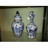 A DELFT POTTERY VASE WITH ELONGATED NECK DEPICTING AN ORIENTAL PAINTED SCENE. H.38cms AND A DELFT