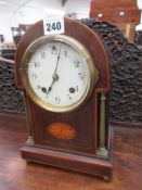 AN EDWARDIAN MAHOGANY AND INLAID 8-DAY STRIKING DESK CLOCK WITH WHITE ENAMEL DIAL AND BRASS BALL