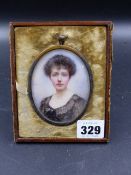 A PORTRAIT MINIATURE OF A DARK HAIRED EDWARDIAN LADY WEARING A BLACK DRESS AND GOLD CHAIN NECKLACE