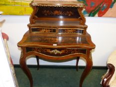 A MARQUETRY INLAID LOUIS XV STYLE ORMOLU MOUNTED WRITING TABLE WITH SHELF AND TWO DRAWERS ABOVE A
