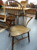 A 19th.C.WINDSOR STICK BACK ARMCHAIR WITH UNUSUAL FRONT RAIL STRETCHER TO TURNED LEGS.