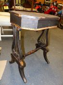 A REGENCY PAINTED LIFT TOP WORK TABLE, PARTIALLY FITTED INTERIOR AND LYRE FORM SUPPORTS ON PAW FEET,