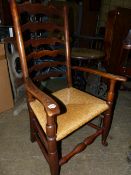 A 19th.C.LANCASHIRE LADDER BACK RUSH SEATED ARMCHAIR.