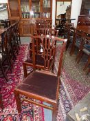 A SET OF SIX CARVED MAHOGANY LATE GEORGIAN CHIPPENDALE DESIGN DINING CHAIRS WITH GOTHIC REVIVAL BACK