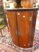 A GEO.III.OAK BOW FRONT WALL HANGING CORNER CABINET WITH SHELVED INTERIOR. W.68 x H.92cms.