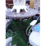 AN ANTIQUE WROUGHT IRON GARDEN OR PATIO TABLE WITH VEINED MARBLE CIRCULAR TOP.Dia.77 x H.73cms.