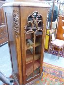 A PAIR OF CONTINENTAL CARVED AND INLAID OAK ART DECO DISPLAY / PIER CABINETS WITH GLAZED DOORS WHICH