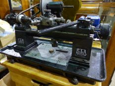 A PULTRA MODEL OR WATCHMAKER'S LATHE WITH CAPSTAN TOOL HEAD AND VARIOUS ATTACHMENTS,