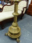 AN IMPRESSIVE BRASS STAND OF GOTHIC INSPIRATION WITH SWIRL COLUMN SUPPORT AND PAW FEET. H.123cms.