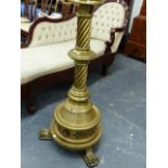 AN IMPRESSIVE BRASS STAND OF GOTHIC INSPIRATION WITH SWIRL COLUMN SUPPORT AND PAW FEET. H.123cms.