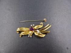 A DIAMOND AND POSSIBLY RUBY GOLD BAR BROOCH, TESTED AS GOLD, LENGTH 5.5cms, WEIGHT 8.9cms.