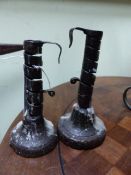 TWO WROUGHT IRON ADJUSTABLE CANDLESTICKS ON TURNED WOOD BASES. LARGEST H.19cms.