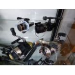 A SHIMANO FISHING REEL ON PIKE FLEX ROD AND FOUR FURTHER SHIMANO REELS. (6) (B)