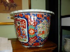 A JAPANESE IMARI JARDINIERE WITH UNUSUAL MOULDED RELIEF FIGURAL DECORATION. Dia.39cms.