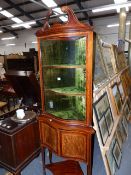 AN EDWARDIAN MAHOGANY AND INLAID SERPENTINE FRONT FLOOR STANDING CORNER CABINET. H.218cms.
