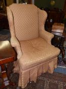 AN EARLY 20th.C.GEO.II.STYLE WING BACK ARMCHAIR ON TURNED LEGS AND STRETCHERS.