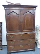 AN 18th.C.AND LATER OAK SECRETAIRE LINEN PRESS WITH A PAIR OF SHAPED PANEL DOORS OVER FALL FRONT