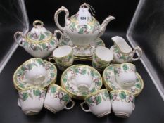 A VICTORIAN STAFFORDSHIRE POTTERY TEA SERVICE WITH VINE LEAF AND FLOWER DECORATION..