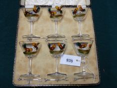 A CASED SET OF SIX ENAMELLED COCKTAIL GLASSES DECORATED WITH FIGHTING COCKS.